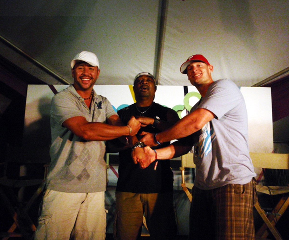 Chuck D of Public Enemy with Moe Train and King B, hands locked together