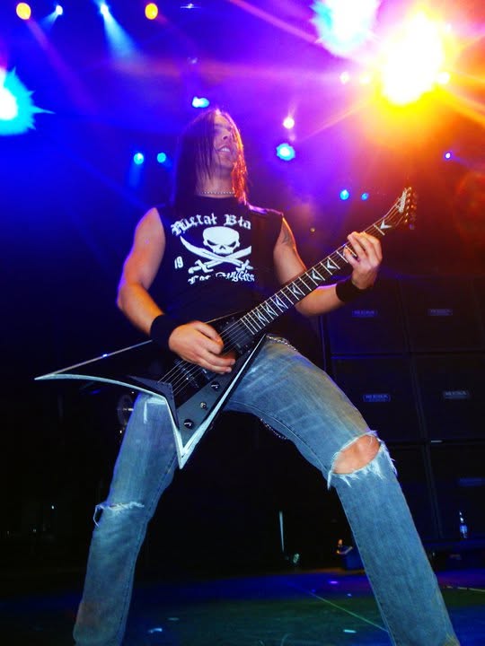Bullet For My Valentine guitarist on stage at Mayhem Fest in Camden under colored lights