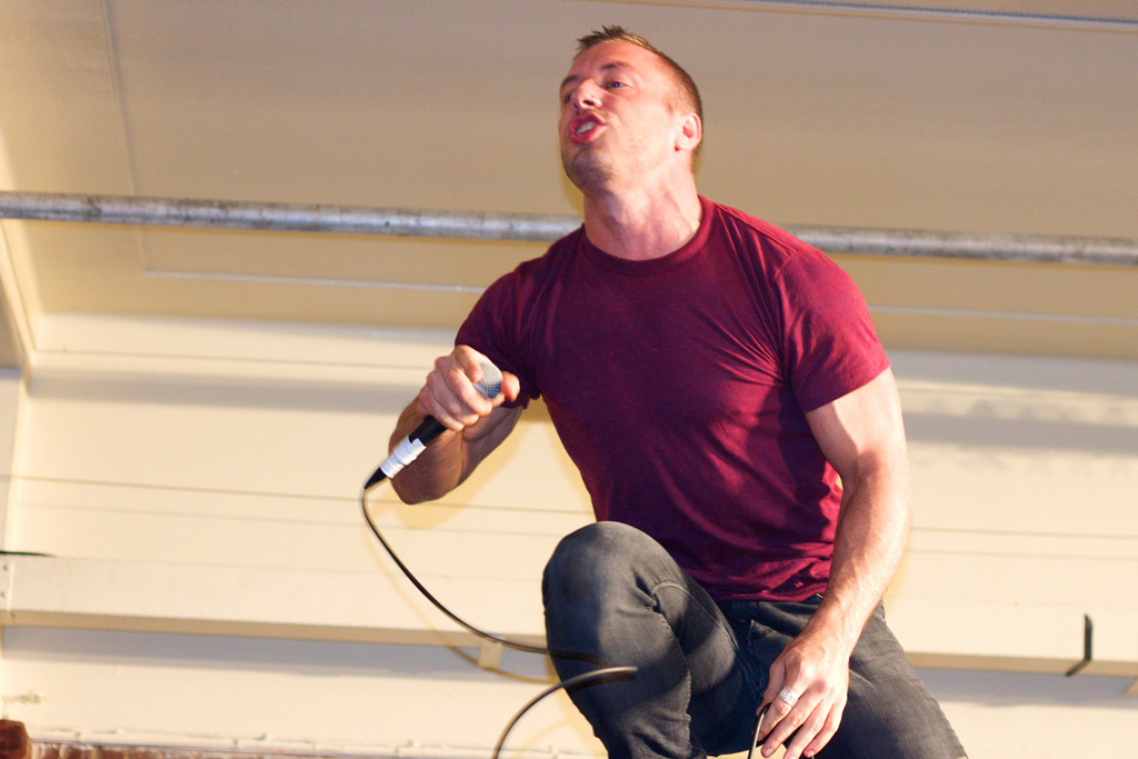 Greg Puciato of Dillinger Escape Plan performing live with a microphone