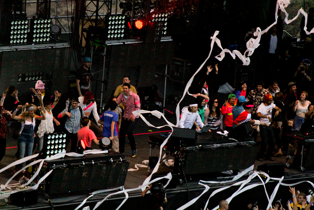 Girl Talk performing live with fans dancing on stage