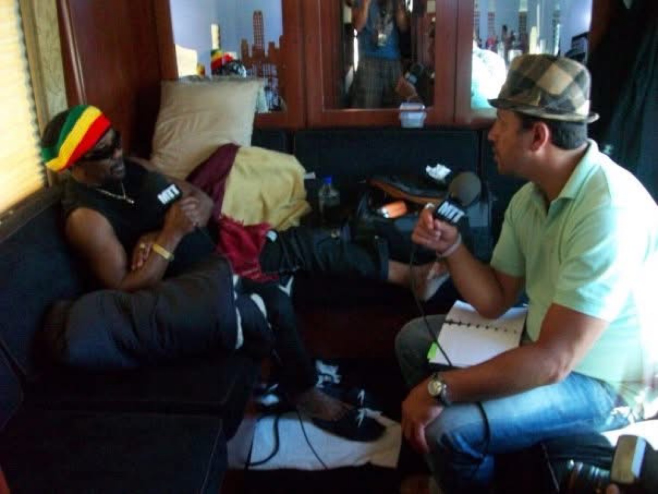 Moe Train interviewing Toots Hibbert on the tour bus, both holding Moe Train's Tracks mics