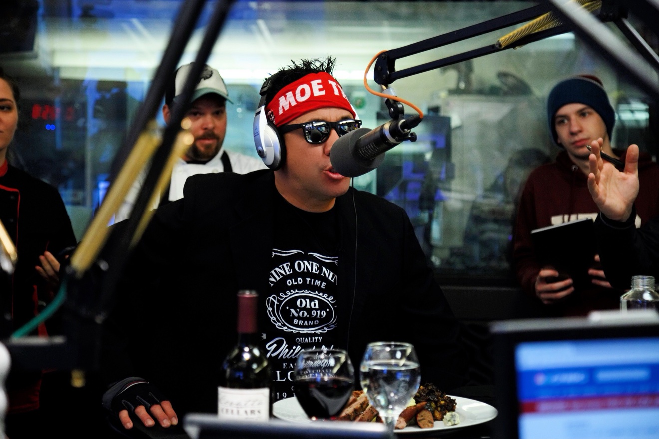 Moe Train at the broadcast microphone in the studio, red MOE TRAIN headband on